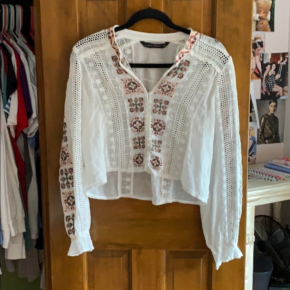 a long sleeve sheer white flowered blouse